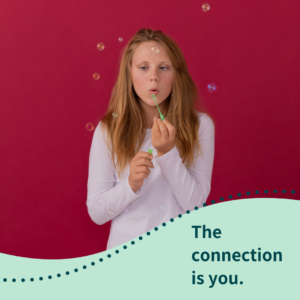 Young girl blowing bubbles with tagline "The connection is you."